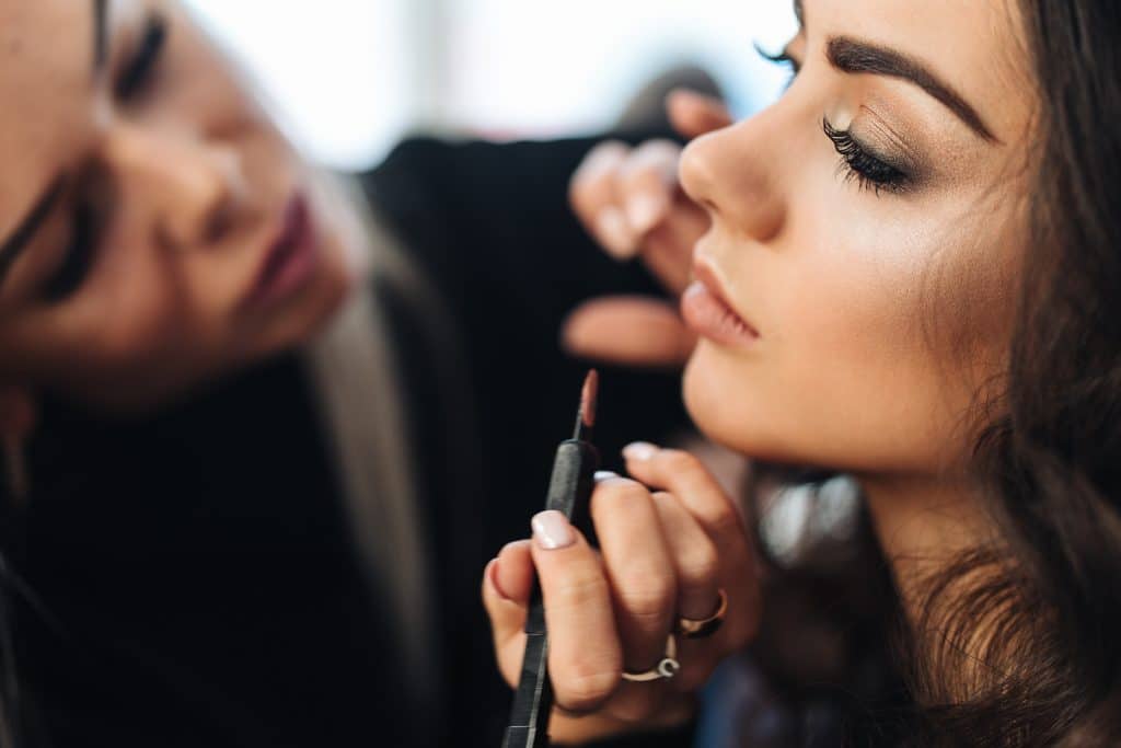 model with makeup being applied