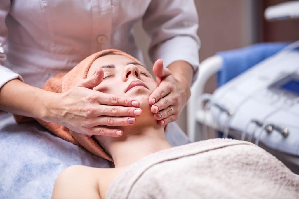 woman spa performing facial